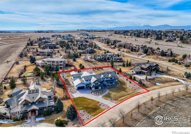 birds eye view of property with a residential view and a mountain view