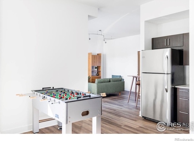 game room with light hardwood / wood-style flooring