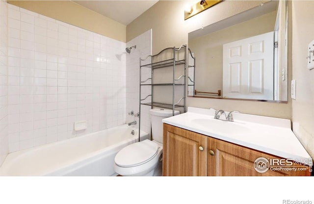 full bathroom featuring vanity, tiled shower / bath combo, and toilet