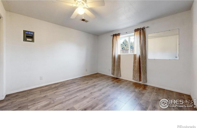 empty room with hardwood / wood-style floors and ceiling fan