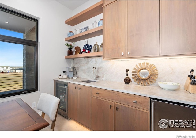 kitchen featuring backsplash, light hardwood / wood-style floors, sink, and wine cooler