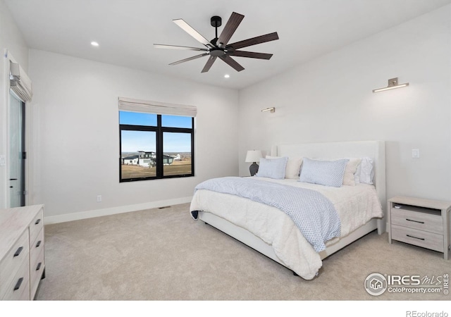 bedroom featuring light colored carpet and ceiling fan