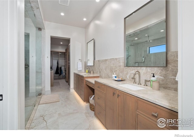 1722 Fire Glow Dr, Windsor, CO 80550 - full bathroom with a shower stall, marble tiled flooring, two vanities, recessed lighting, and tasteful backsplash