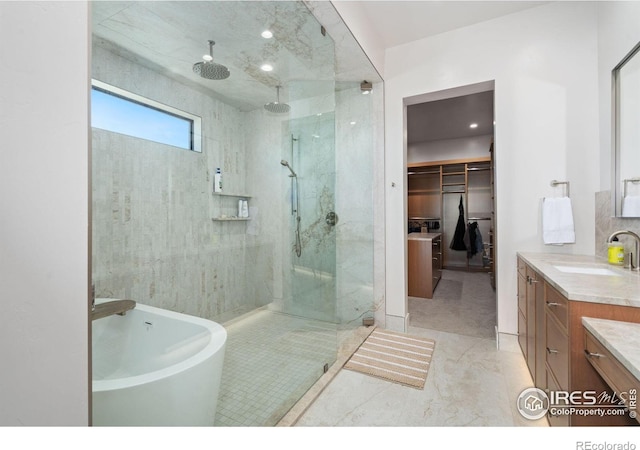 bathroom featuring vanity, tile patterned flooring, and plus walk in shower