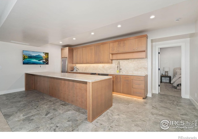 1722 Fire Glow Dr, Windsor, CO 80550 - kitchen featuring light countertops, recessed lighting, a sink, backsplash, and a peninsula