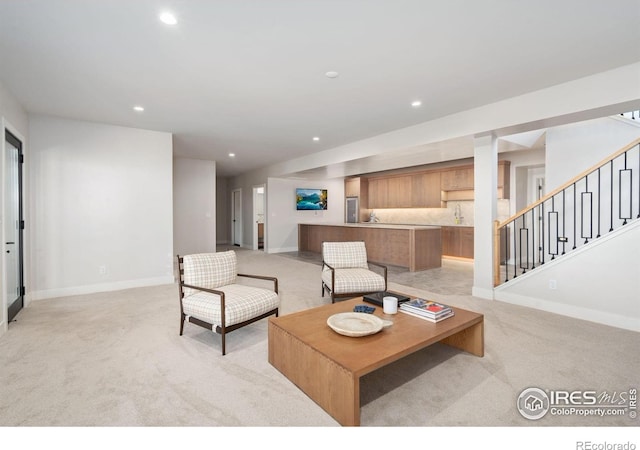 1722 Fire Glow Dr, Windsor, CO 80550 - living area with light colored carpet, baseboards, stairs, and recessed lighting