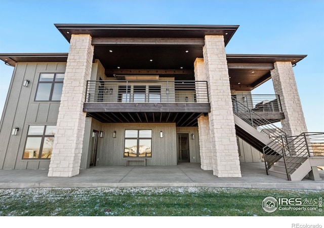 1722 Fire Glow Dr, Windsor, CO 80550 - rear view of property with a balcony, a patio, and stairs