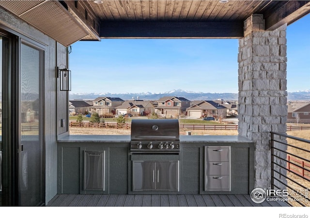 view of patio featuring a mountain view, an outdoor kitchen, and a grill