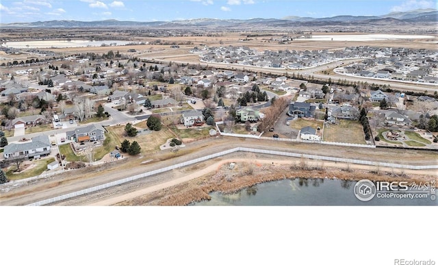 birds eye view of property with a water and mountain view