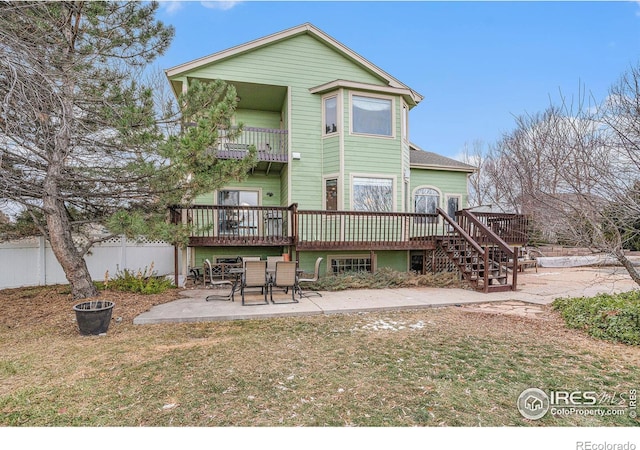 rear view of property featuring a patio area and a wooden deck