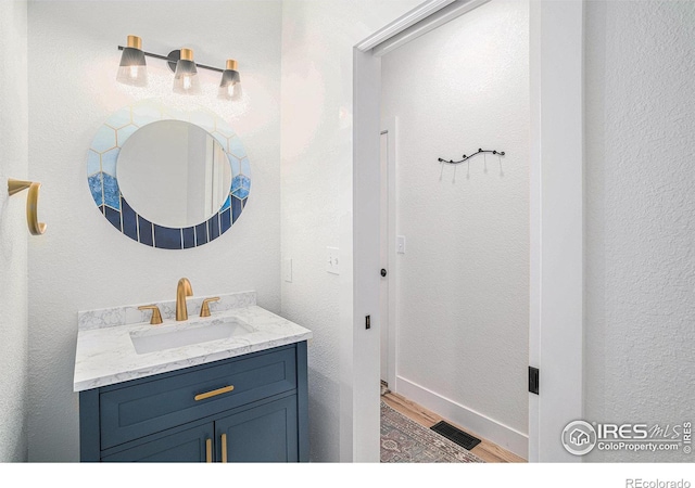 bathroom with hardwood / wood-style floors and vanity