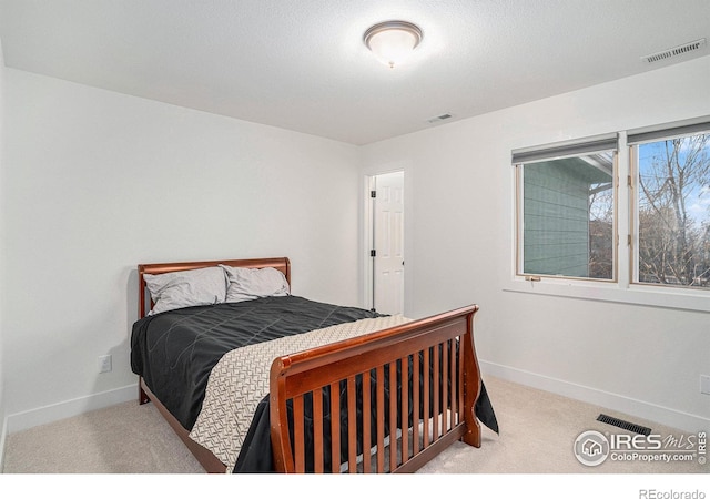 bedroom featuring light carpet