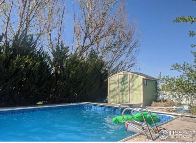 view of pool with a shed