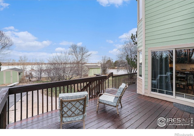 wooden terrace with a storage shed