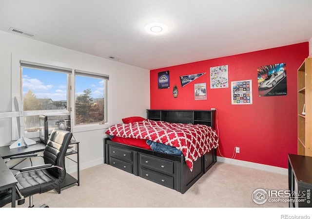 bedroom featuring light carpet