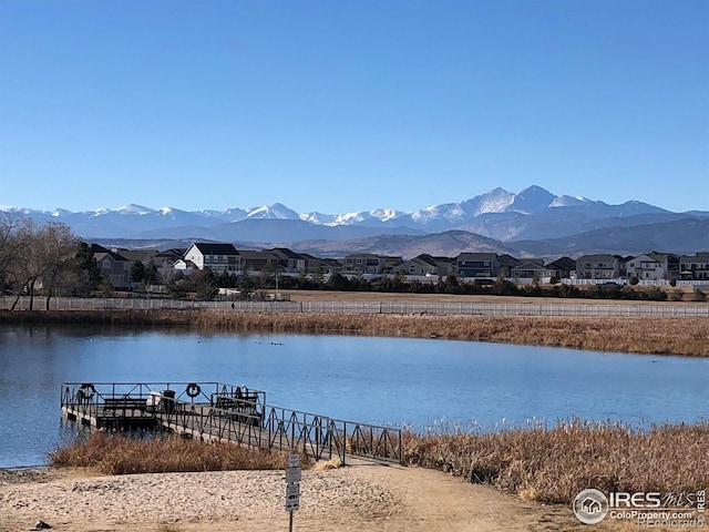 view of dock with a water and mountain view