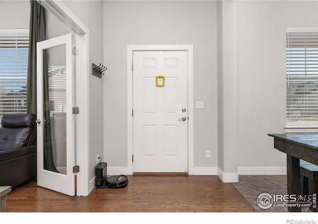 entryway with dark hardwood / wood-style floors