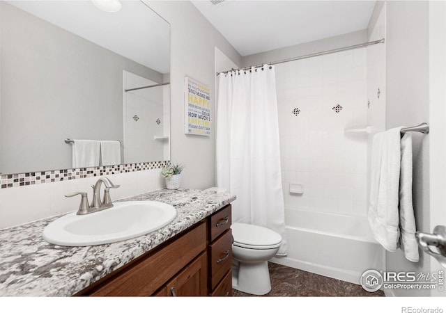 full bathroom featuring backsplash, shower / bath combo with shower curtain, vanity, and toilet