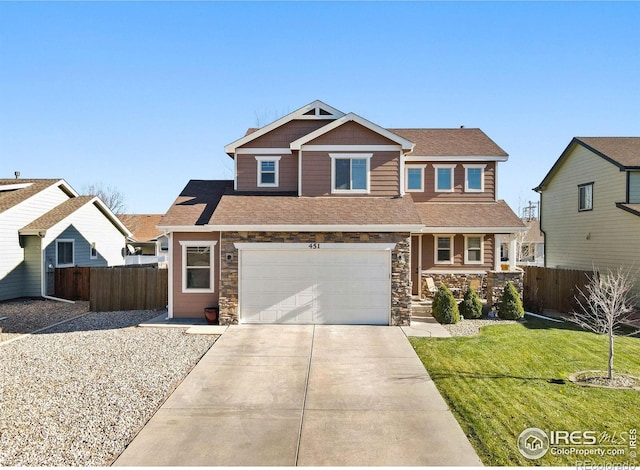 craftsman inspired home with a front yard and a garage