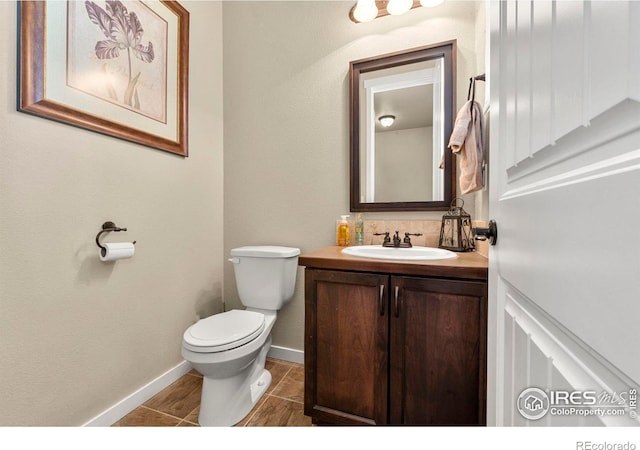 bathroom with tile patterned floors, vanity, and toilet