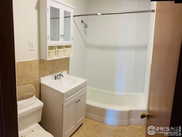 full bathroom featuring vanity, shower / bathing tub combination, tile walls, tile patterned flooring, and toilet