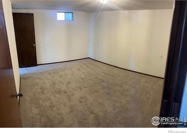 basement with light carpet and a textured ceiling