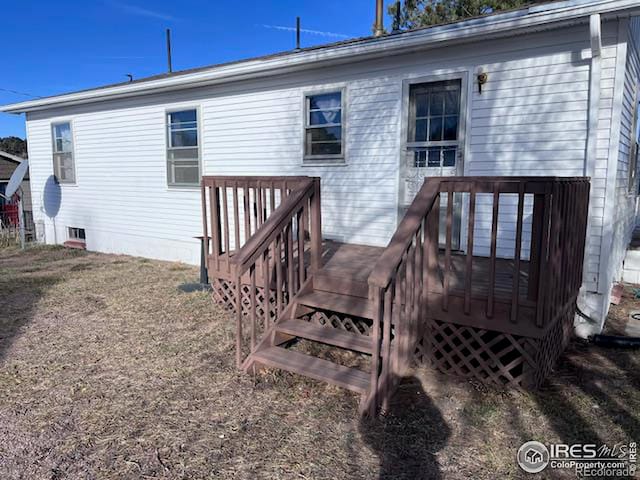 back of house with a deck