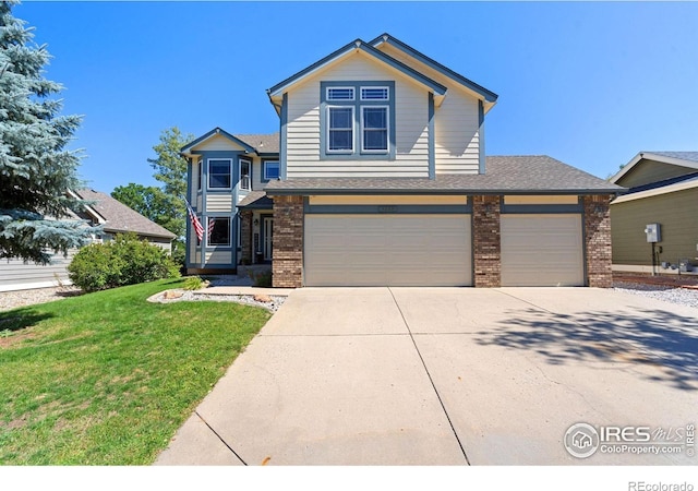 front facade featuring a front yard and a garage