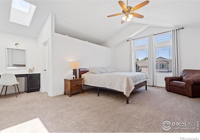 bedroom featuring light carpet, lofted ceiling with skylight, and ceiling fan