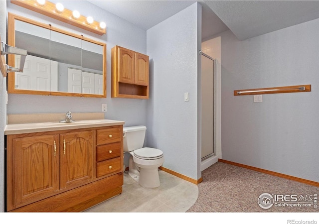 bathroom with vanity, toilet, and a shower with shower door