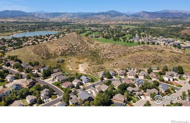 drone / aerial view with a water and mountain view