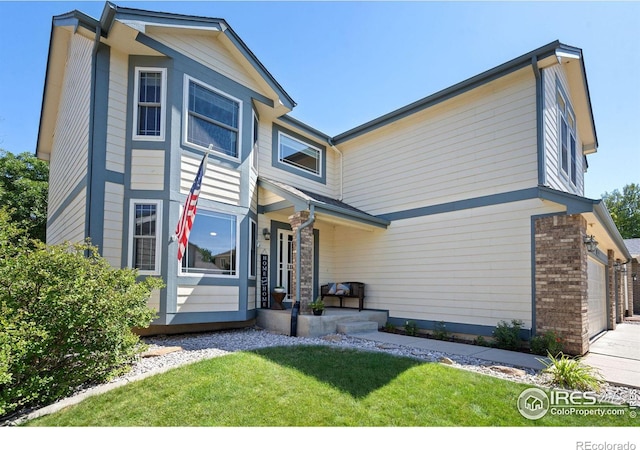 view of front facade with a front yard and a garage