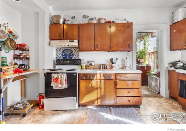 kitchen with light tile patterned floors and white electric range oven