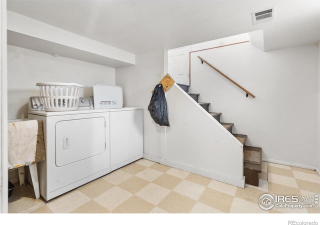 laundry area with independent washer and dryer