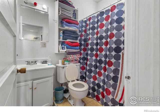 bathroom with curtained shower, tile patterned flooring, vanity, and toilet