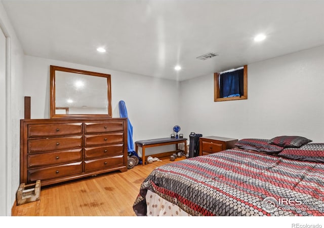 bedroom with hardwood / wood-style flooring