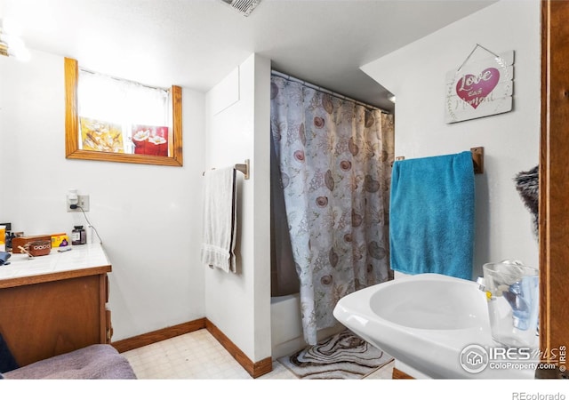 bathroom featuring vanity and shower / bath combination with curtain