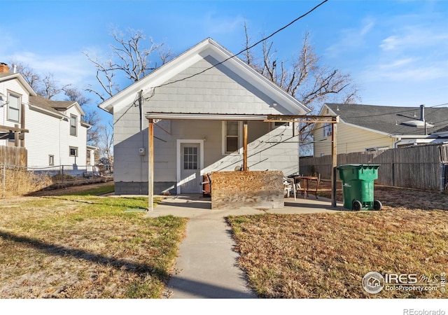 back of property featuring a lawn and a patio