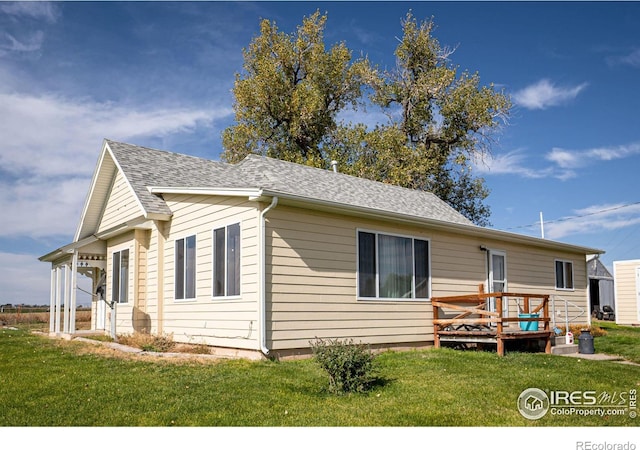 view of property exterior featuring a lawn and a deck