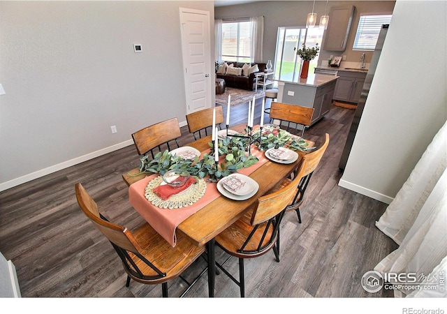 dining space with dark wood-type flooring and sink