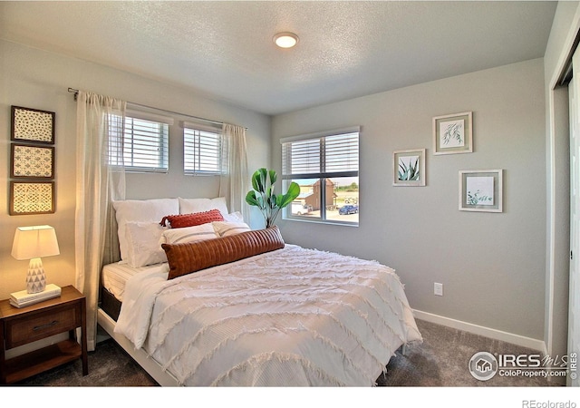 carpeted bedroom with a textured ceiling