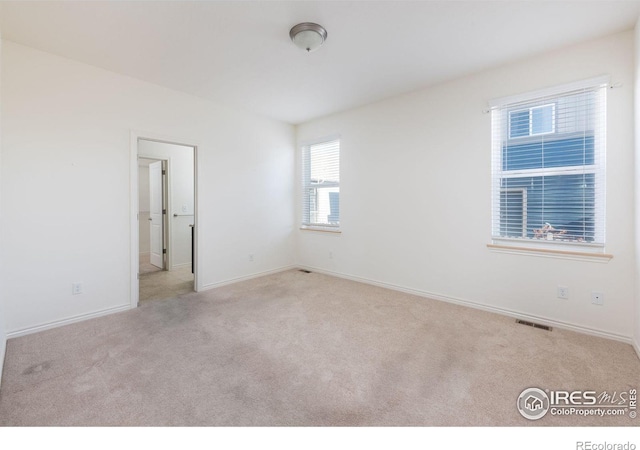 empty room featuring light colored carpet