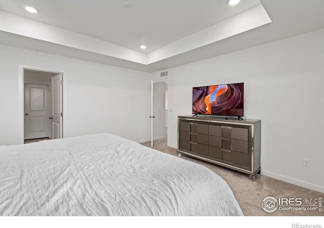 bedroom with visible vents, a raised ceiling, baseboards, carpet, and recessed lighting