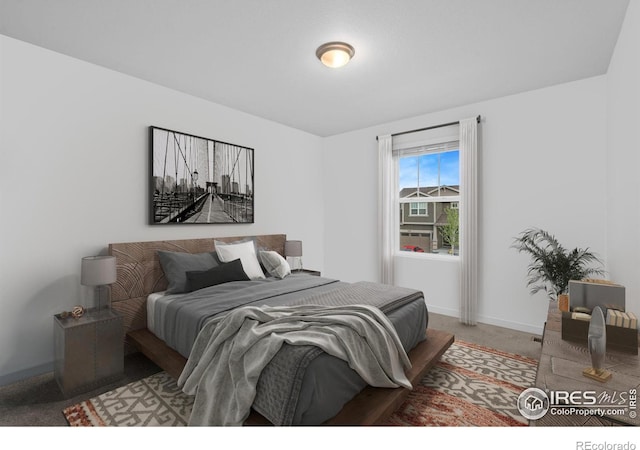 bedroom with baseboards and light colored carpet