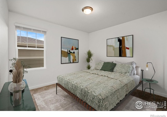 bedroom with carpet flooring and baseboards