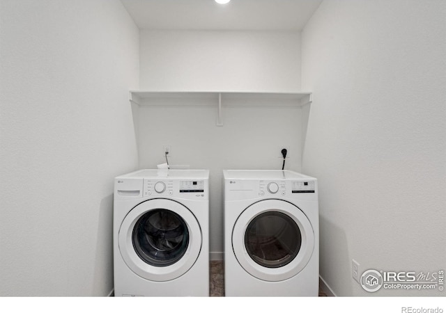 clothes washing area with independent washer and dryer