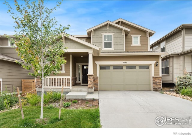 craftsman inspired home featuring stone siding, covered porch, driveway, and an attached garage