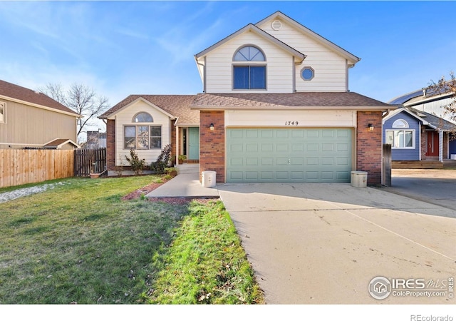 view of front property featuring a garage and a front lawn