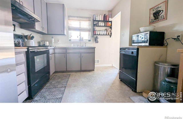 kitchen featuring gray cabinets, sink, and black appliances