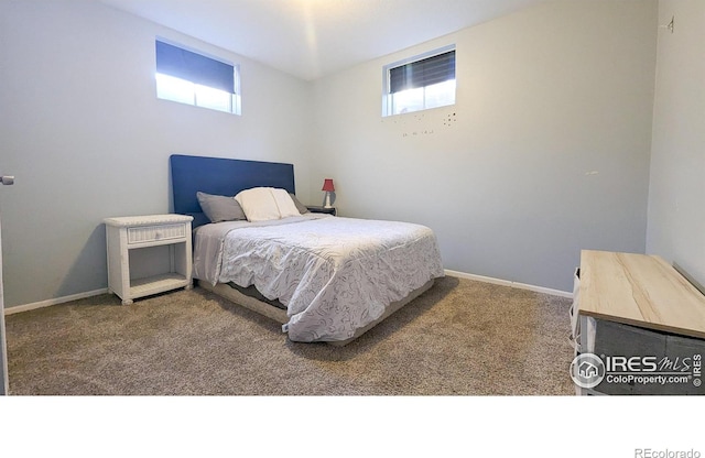 bedroom with carpet flooring and multiple windows